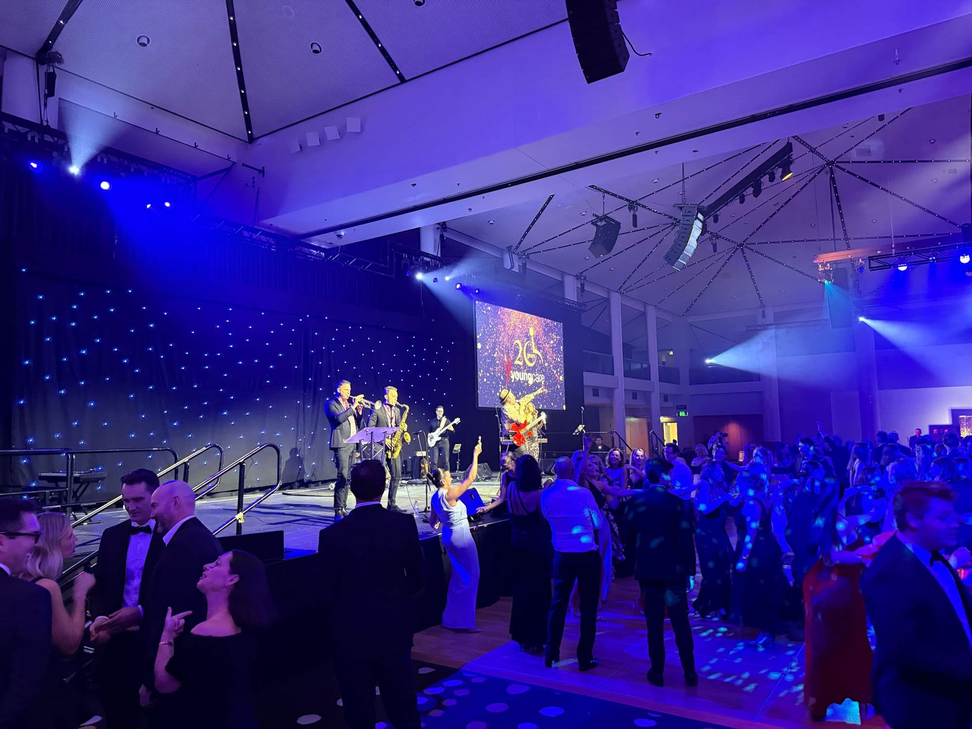 The Youngcare gala mid-set, the band on stage and the dance floor filling
