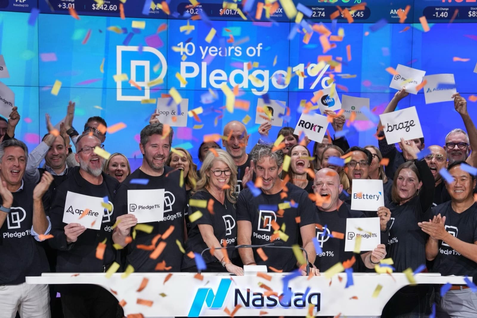 Pledge 1% members celebrating 10 years of the movement at the Nasdaq opening bell, under falling confetti