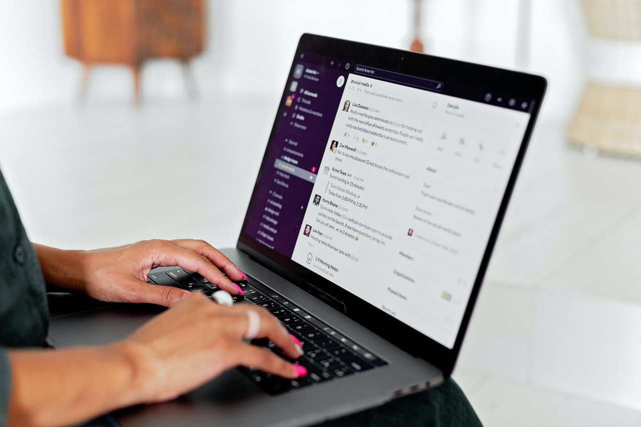 Woman chatting on her laptop using slack