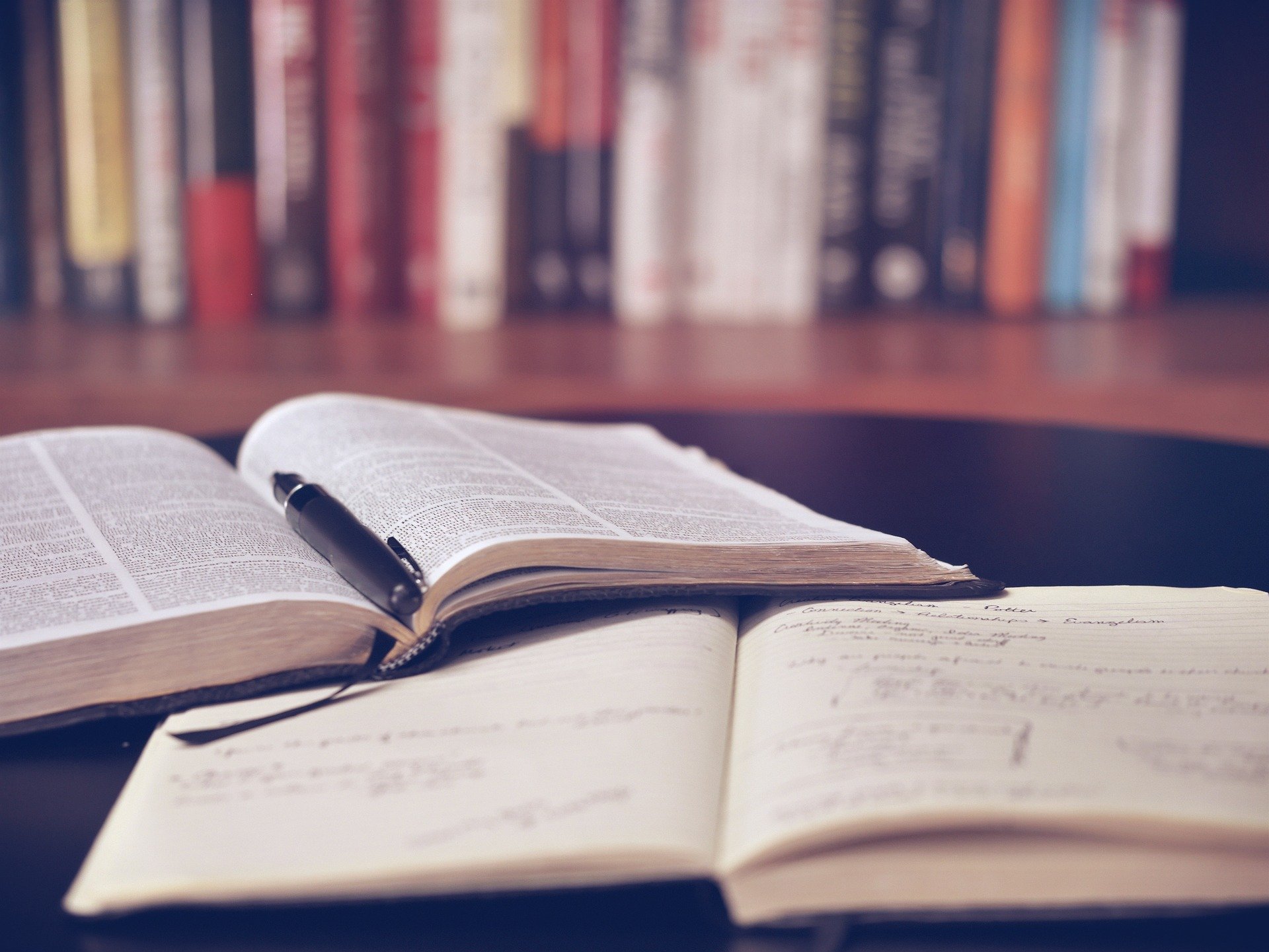 two open books laying on a table